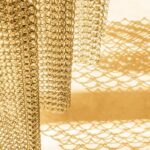Metal coil drapery in a gold finish by KAPHS
