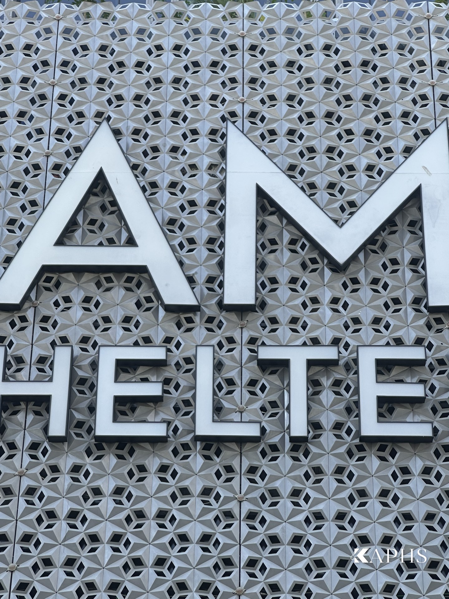Close-up of the MAMA SHELTER signage on the Mashrabiya screen, Business Bay Dubai — KAPHS