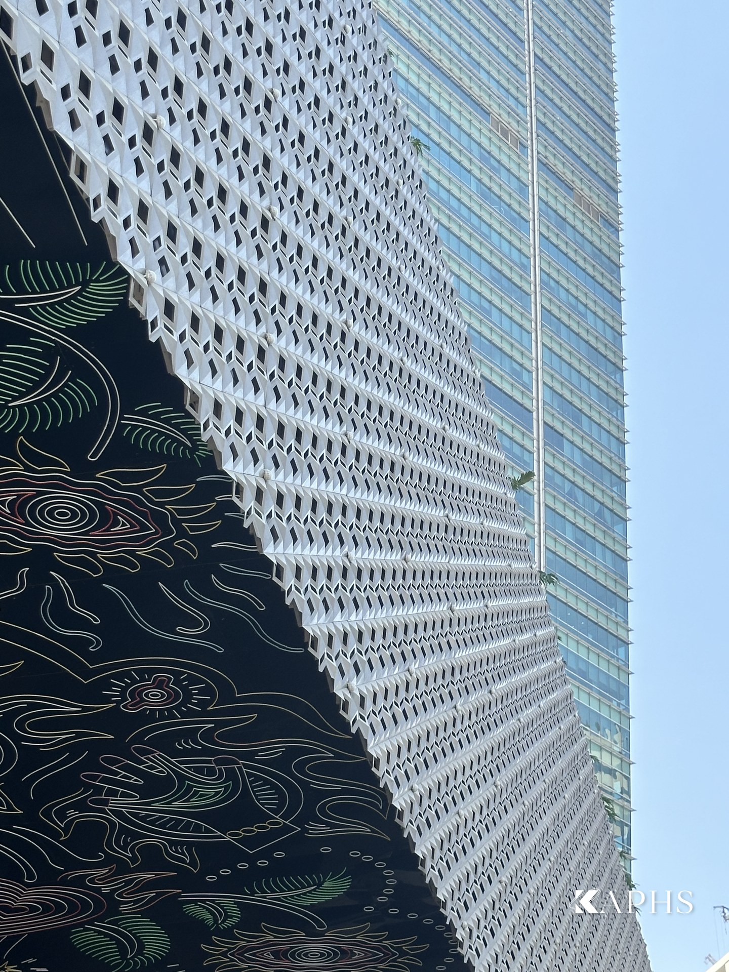 Cast-aluminium arrow-slit Mashrabiya screen against the Dubai skyline, Mama Shelter Hotel — KAPHS