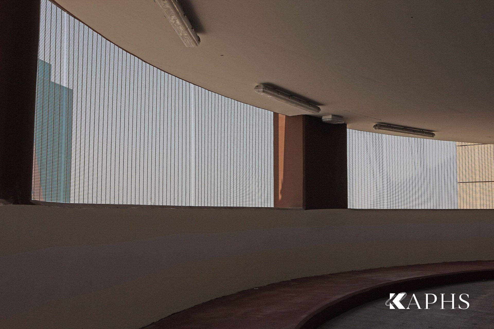 Daylight filtering through the stainless woven wire mesh façade, Al Naeem Mall car park RAK — KAPHS