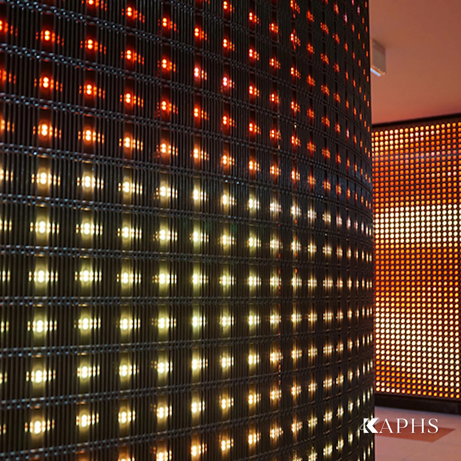 Warm-lit IMAGIC WEAVE LED architectural wire mesh column, Al Sadd Sports Club Doha — KAPHS