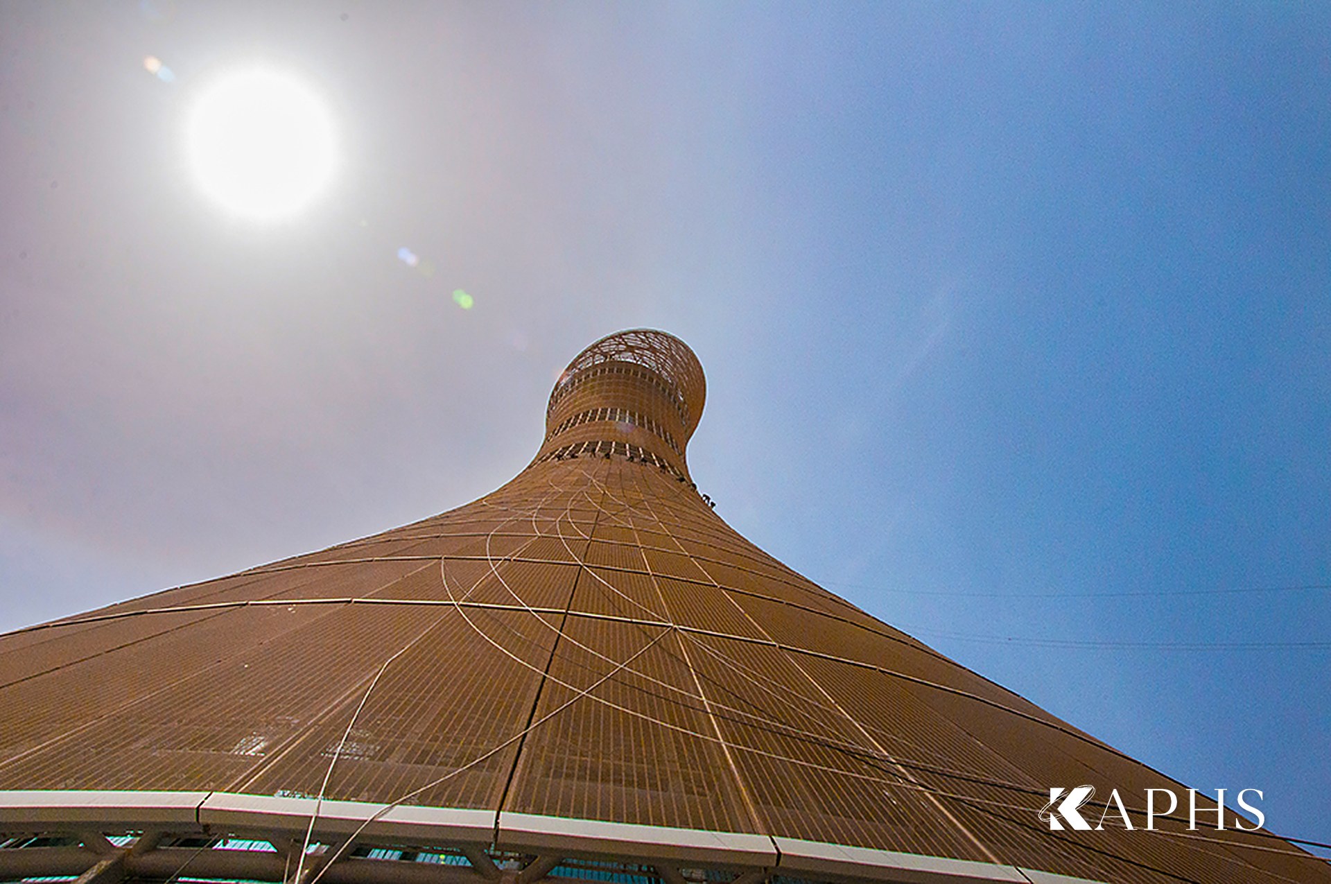Aspire Tower's tapering architectural wire mesh façade against the sky, Doha — KAPHS