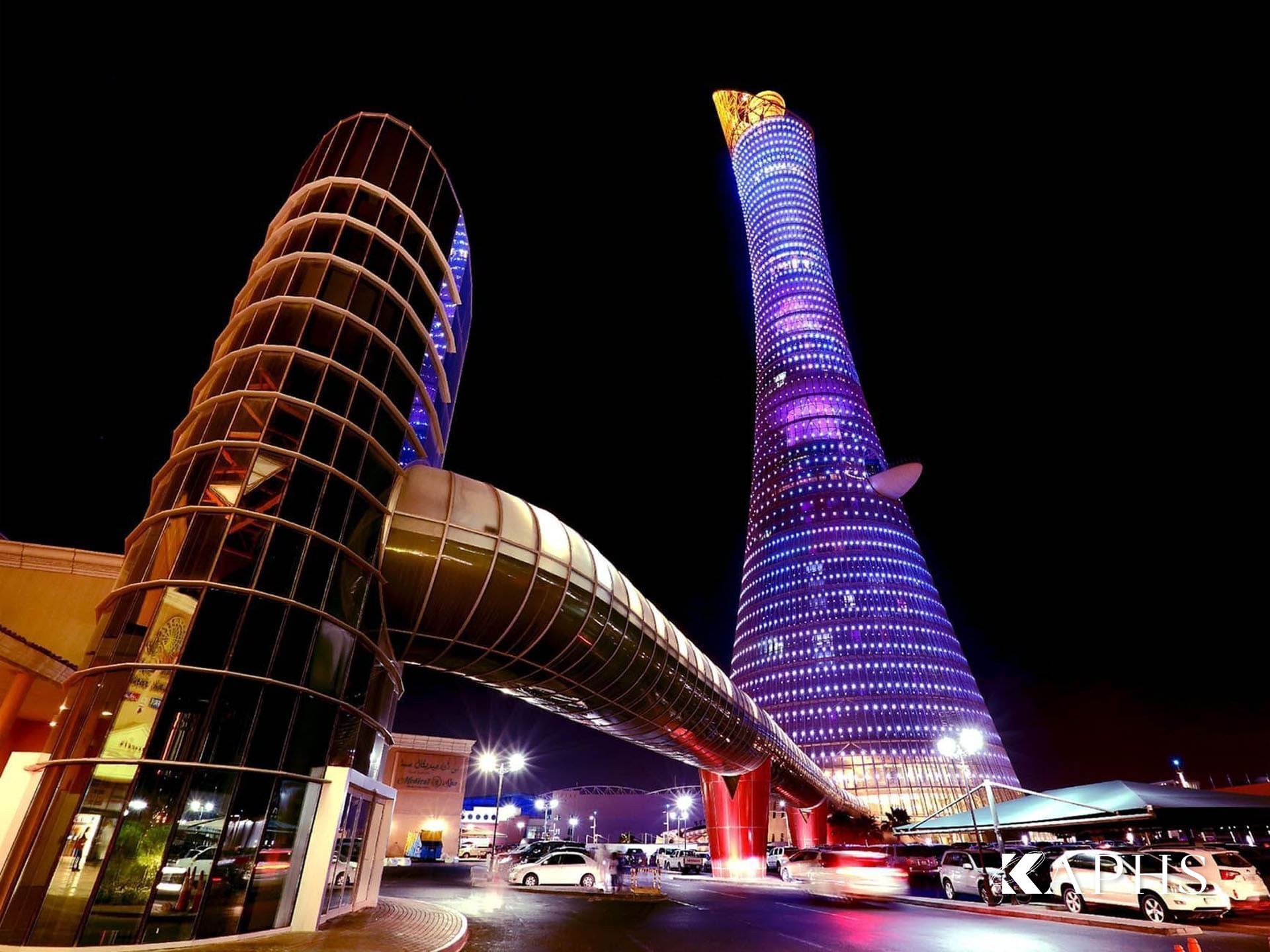 Aspire Torch Tower glowing blue at night through its LED-integrated wire mesh façade, Doha — KAPHS