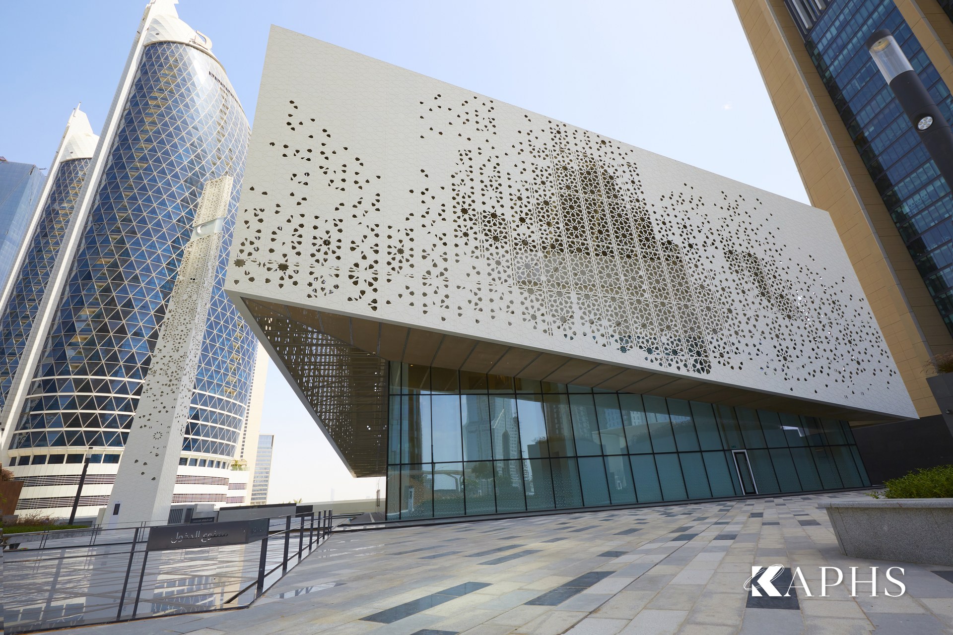 DIFC Gate Mosque wire mesh solar-shading façade against the DIFC towers, Dubai — KAPHS