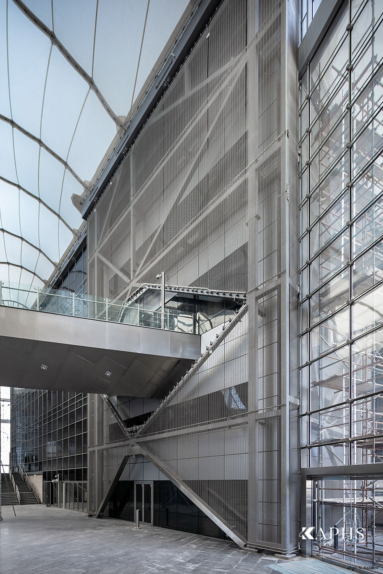 Interior stair framed by architectural wire mesh solar screening, Energy City Qatar — KAPHS