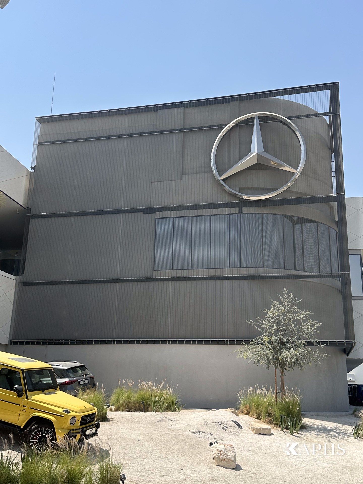 Grey architectural wire mesh façade with Mercedes-Benz star, Dubai d3 showroom — KAPHS