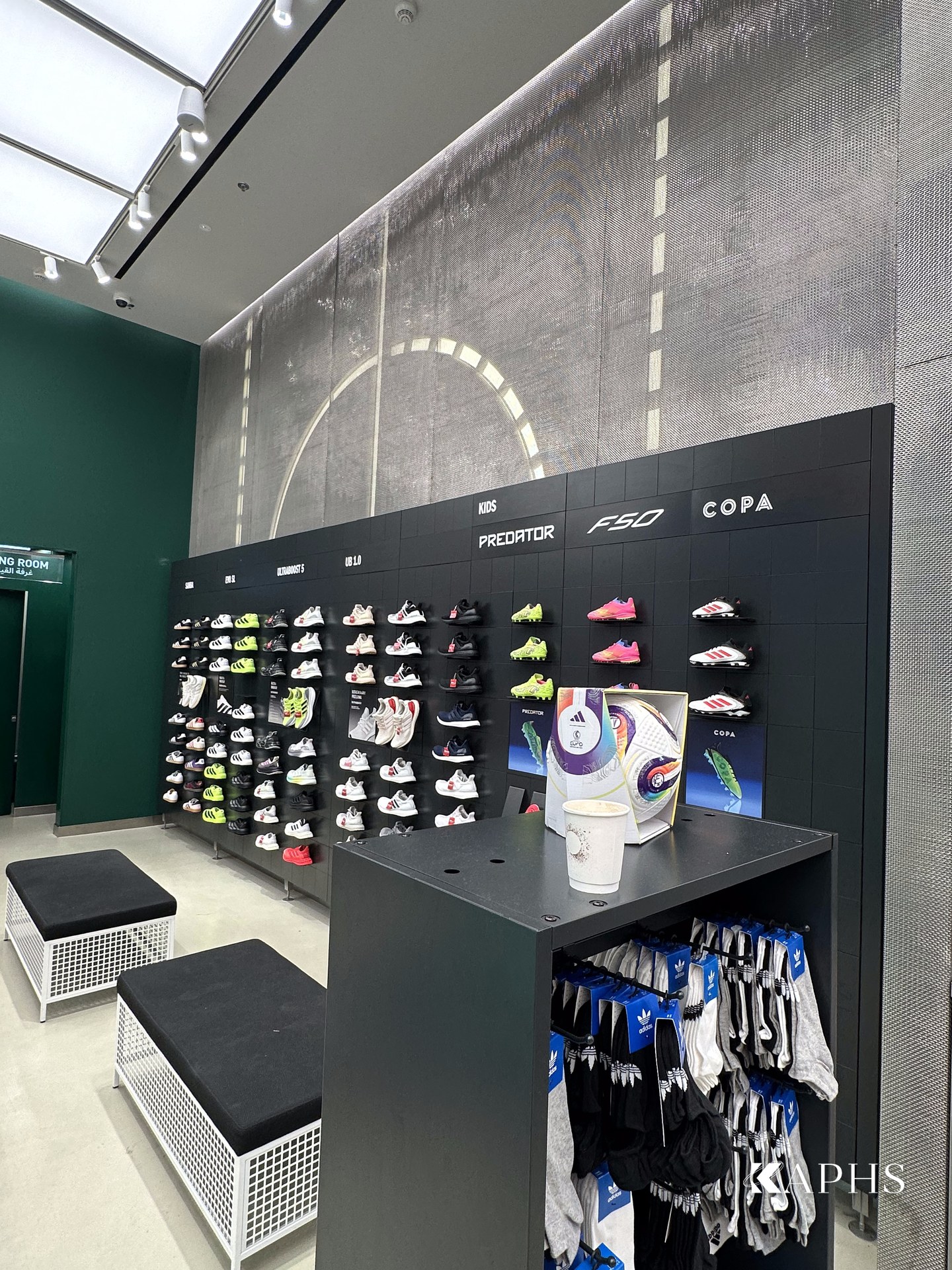 Retail display against DWM Mosa decorative wire mesh cladding, Adidas Young Athletes store Dubai Mall — KAPHS