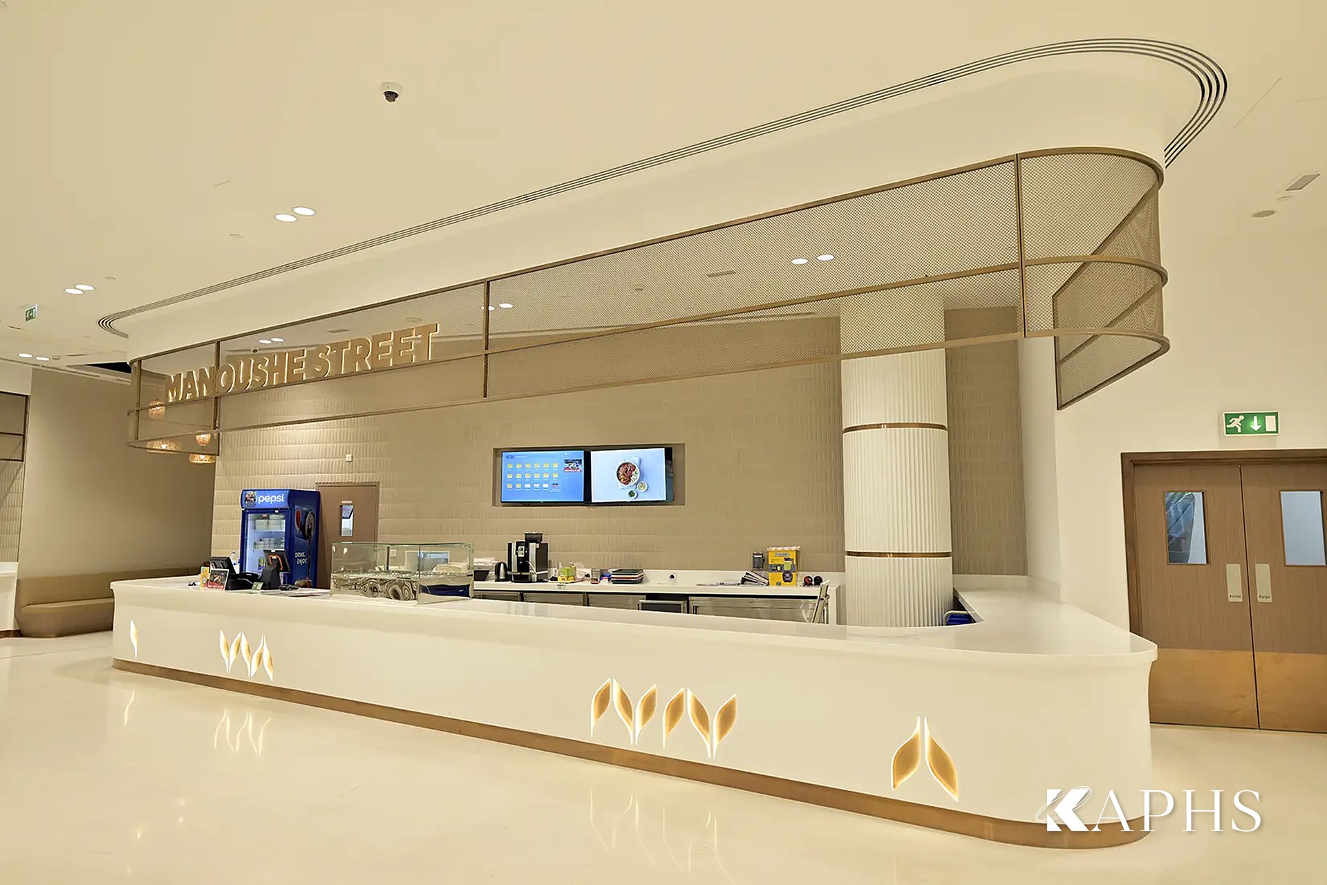 Servery counter framed by bronze decorative wire mesh, DAFZA Food Court Dubai — KAPHS