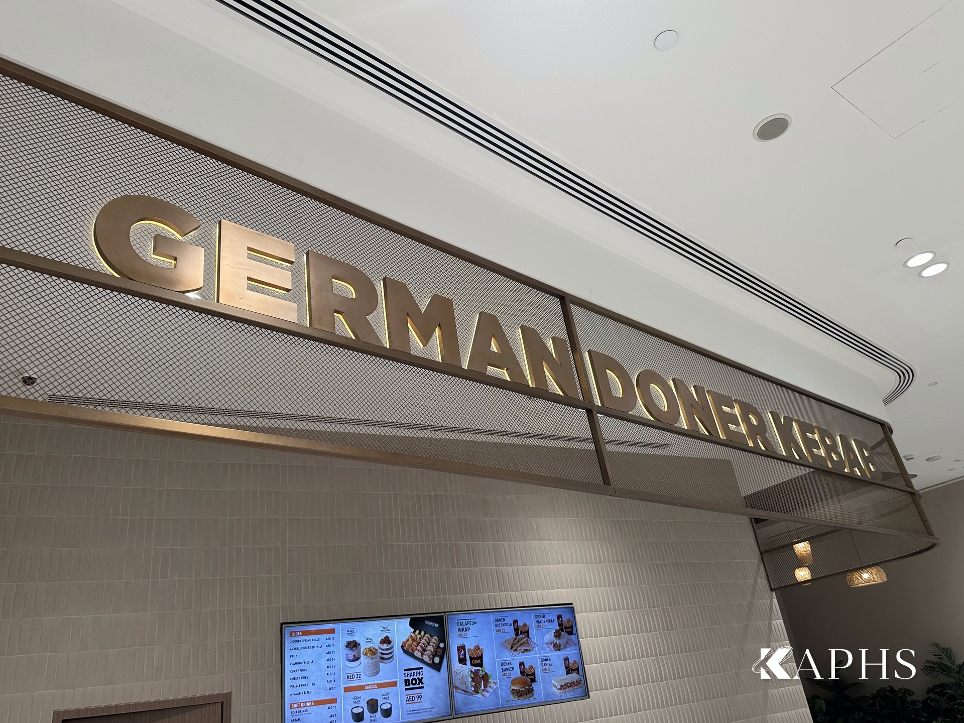 German Doner Kebab signage on a bronze decorative wire mesh façade, DAFZA Food Court Dubai — KAPHS