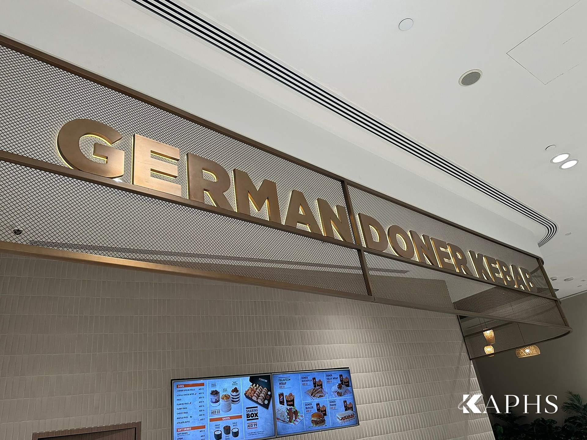 German Doner Kebab stall with bronze decorative wire mesh backdrop, DAFZA Food Court Dubai — KAPHS