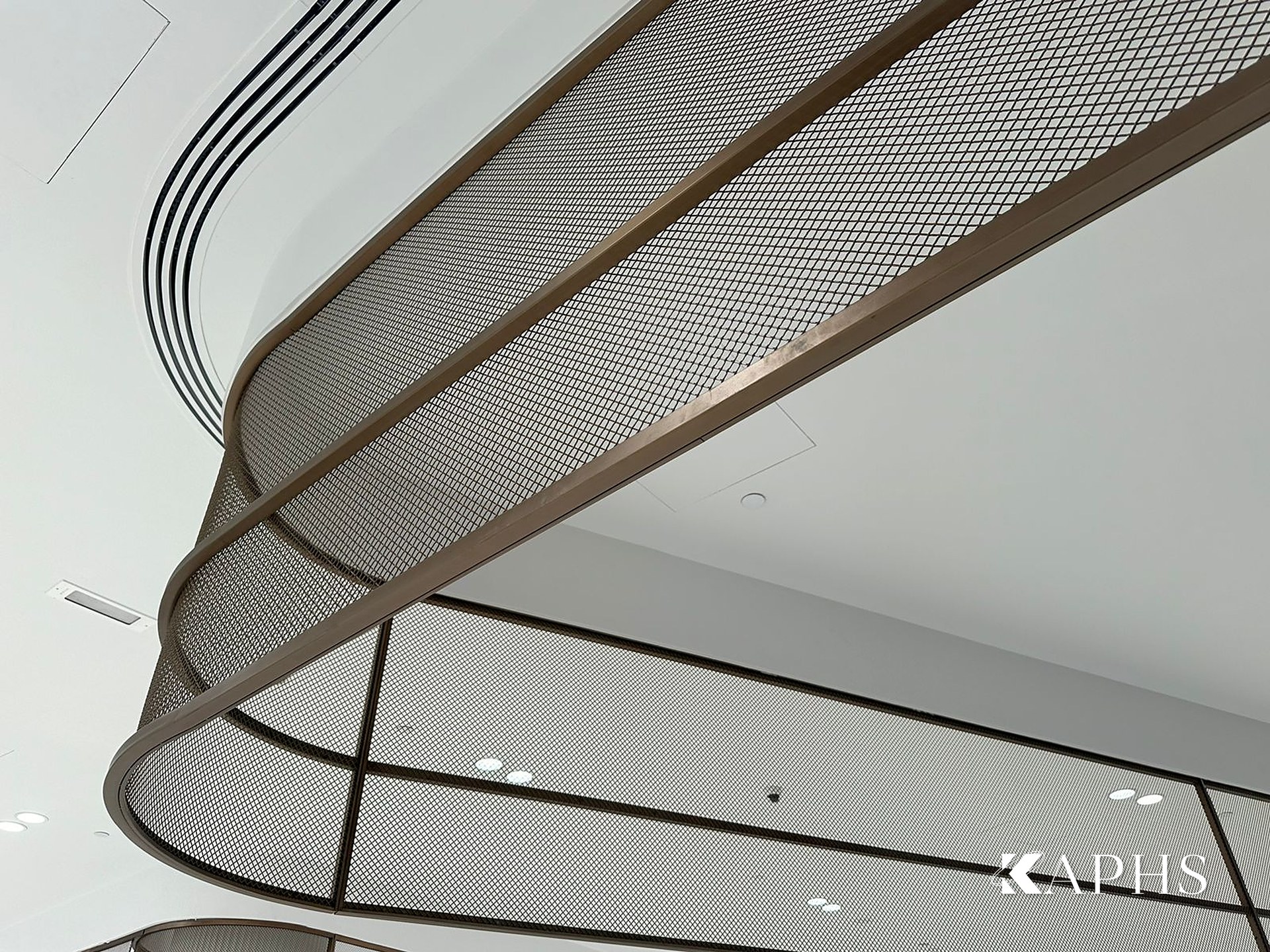 Detail of curved bronze flat-wire decorative wire mesh panel, DAFZA Food Court Dubai — KAPHS