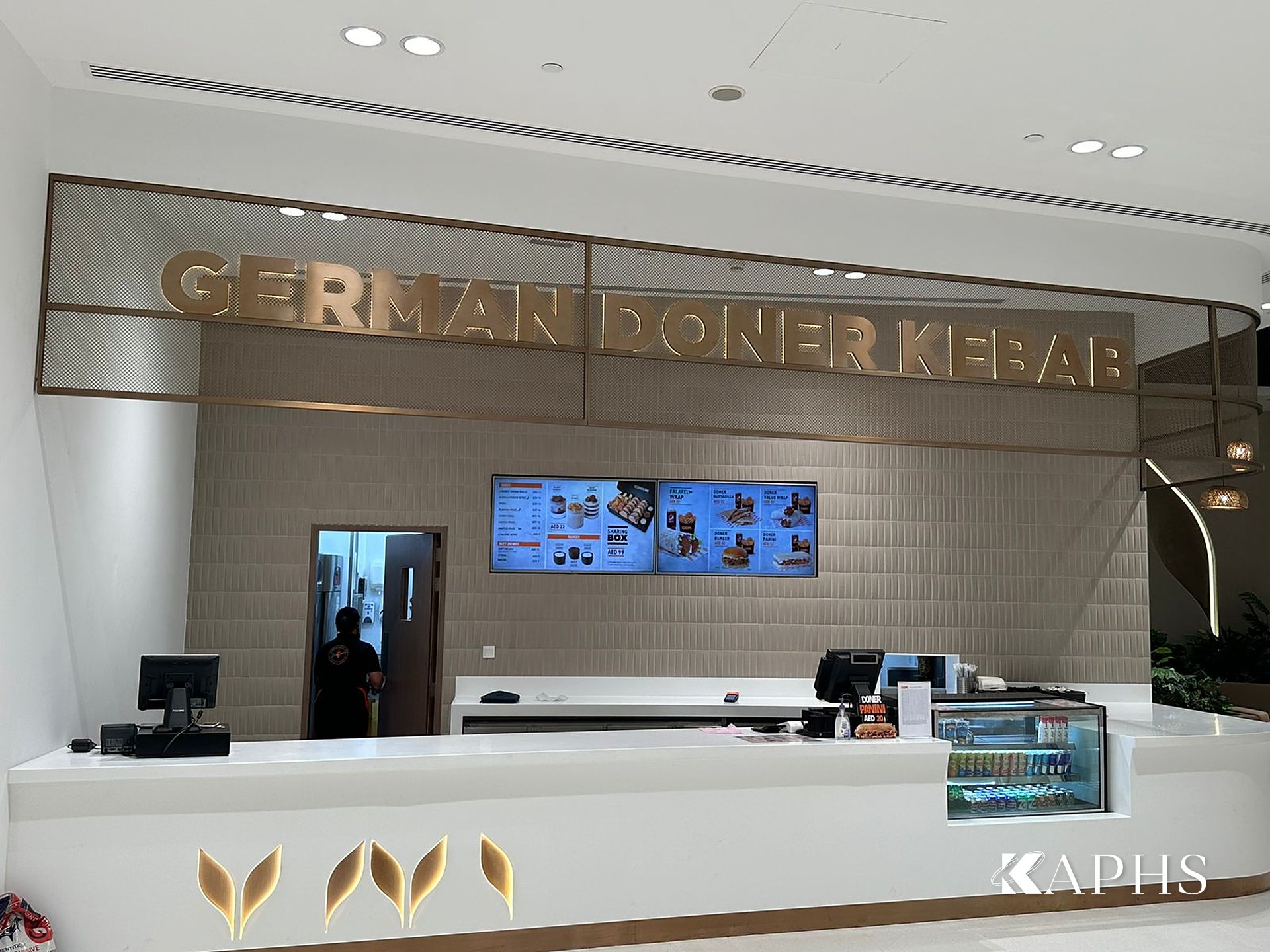 German Doner Kebab counter with bronze decorative wire mesh backdrop, DAFZA Food Court Dubai — KAPHS