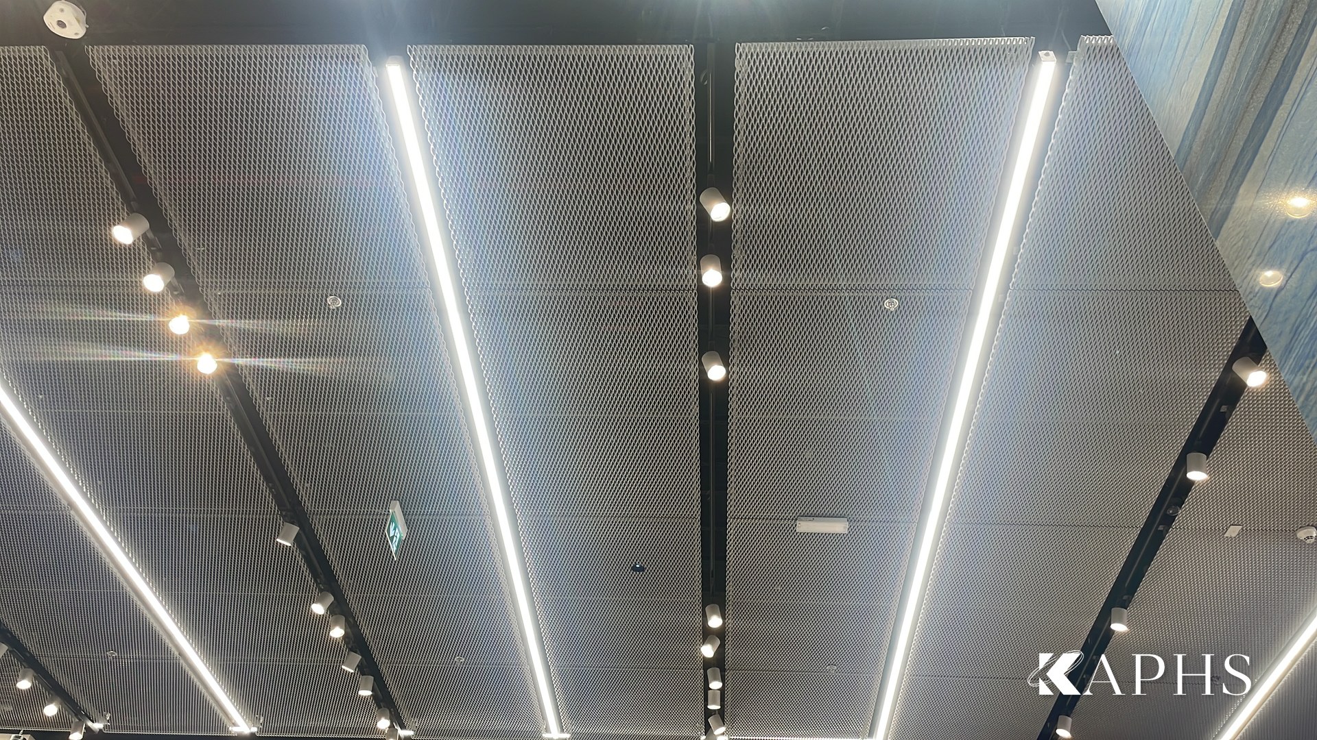Framed ExpandForm expanded metal mesh ceiling with linear lighting, Adidas Originals Dubai Mall — KAPHS