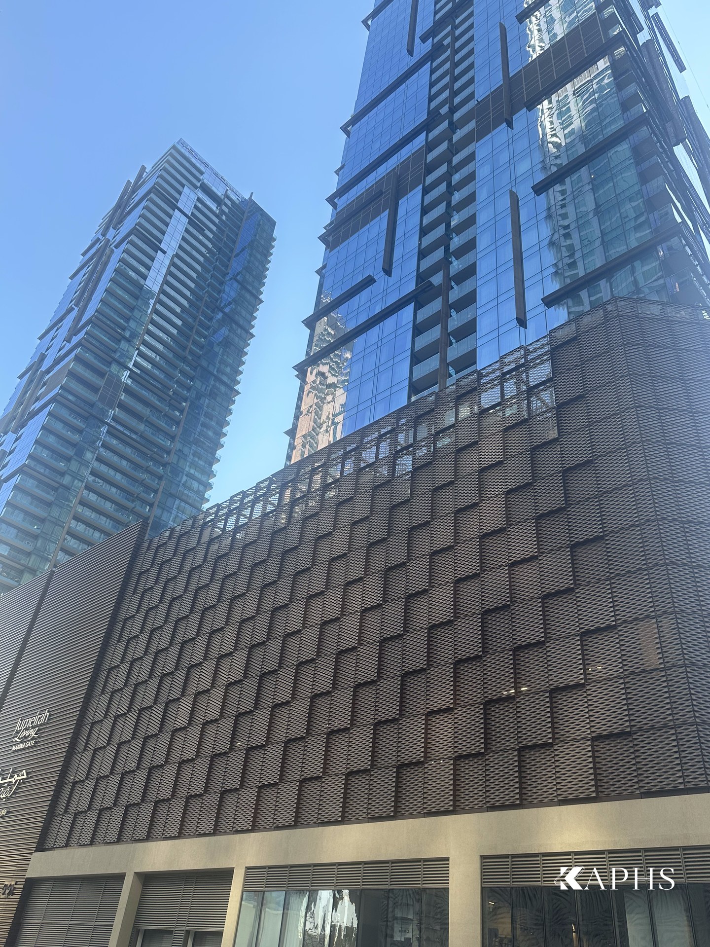 Marina Gate Tower 3 rising above its ExpandForm expanded metal mesh car-park cladding, Dubai — KAPHS