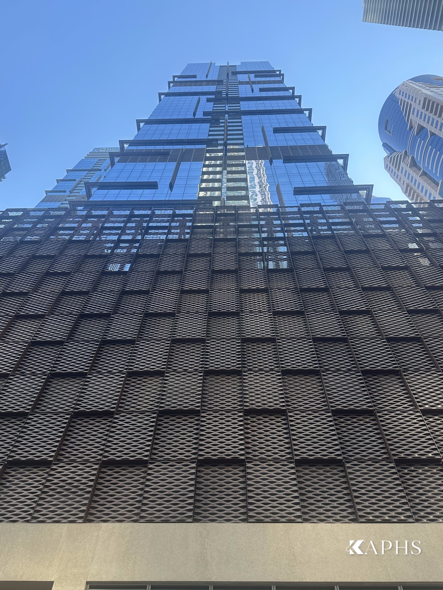 Looking up the ExpandForm expanded metal mesh car-park façade, Marina Gate Tower 3 Dubai — KAPHS