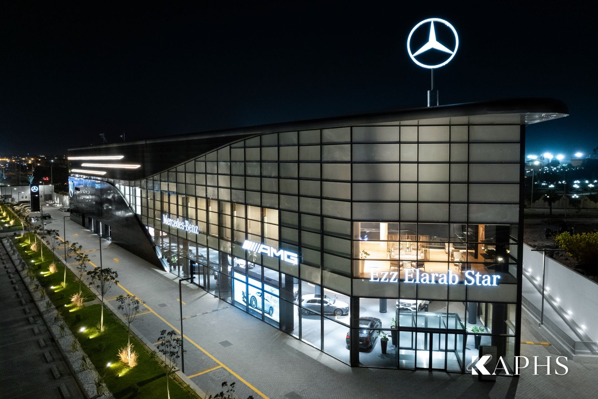 Mercedes-Benz Ezz Al Arab Star showroom lit at night behind its expanded metal mesh double skin, Giza — KAPHS