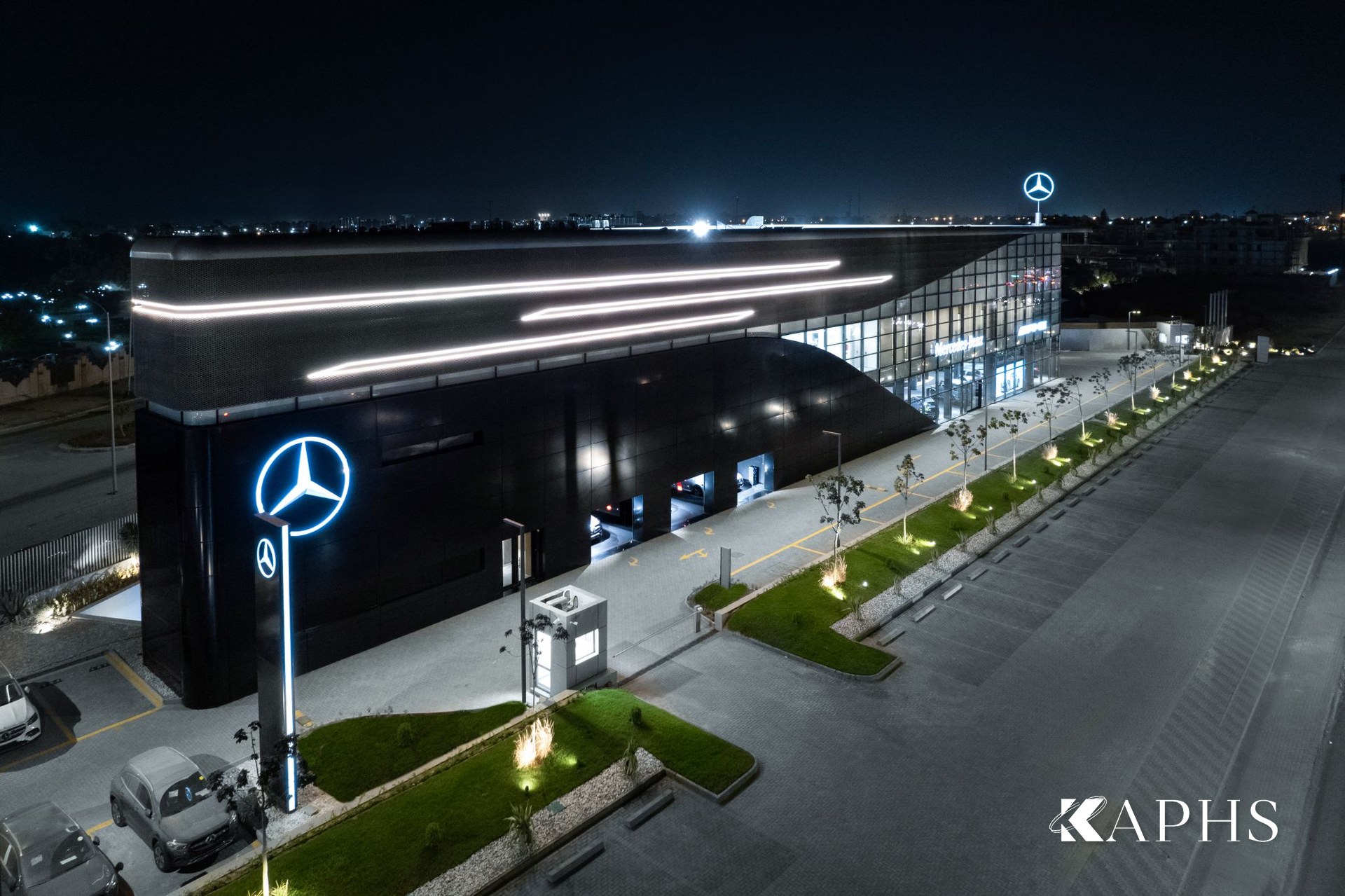 Mercedes-Benz Ezz Al Arab Star showroom illuminated at night, expanded metal mesh curtain-wall skin, Egypt — KAPHS