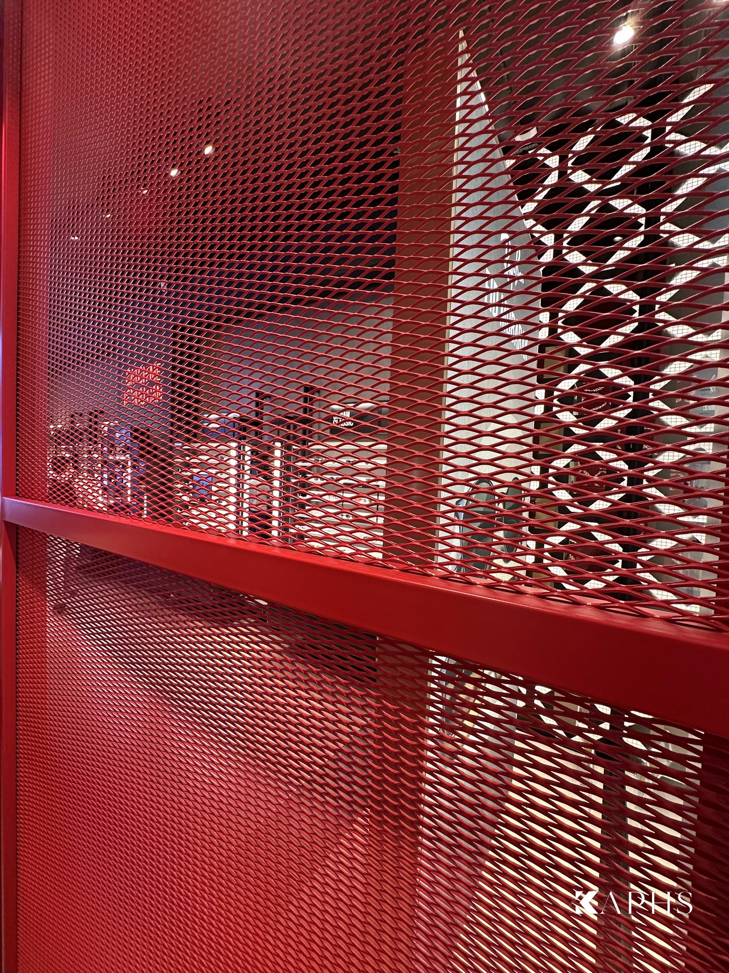 Close-up of the red ExpandForm expanded metal mesh screen, Ray-Ban store The Dubai Mall — KAPHS