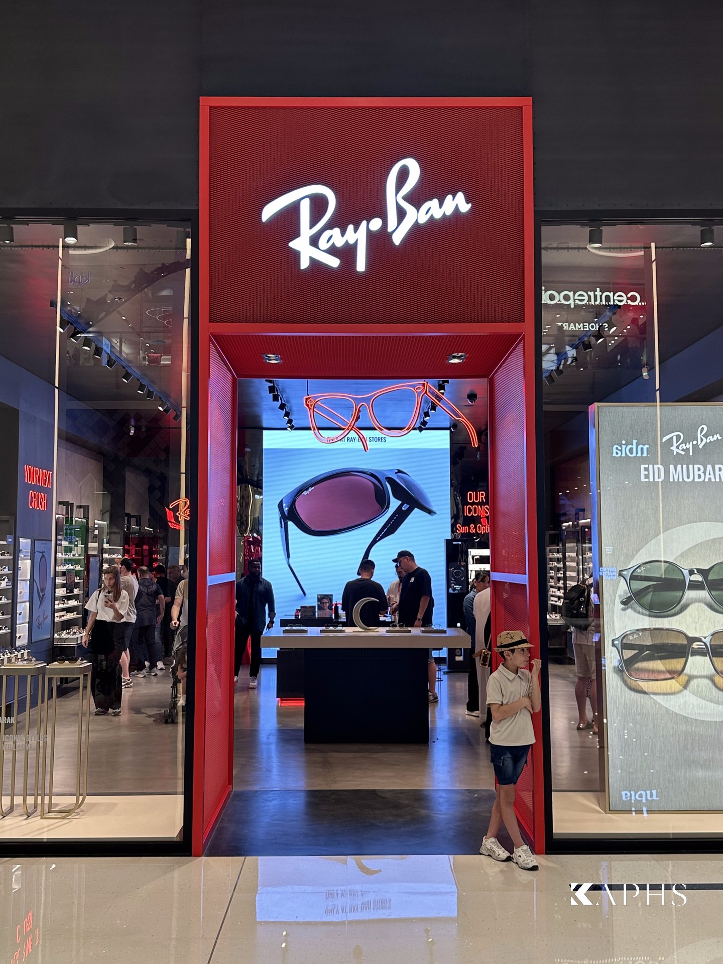 Full storefront of the Ray-Ban store, The Dubai Mall — red ExpandForm expanded metal mesh with illuminated signage, KAPHS