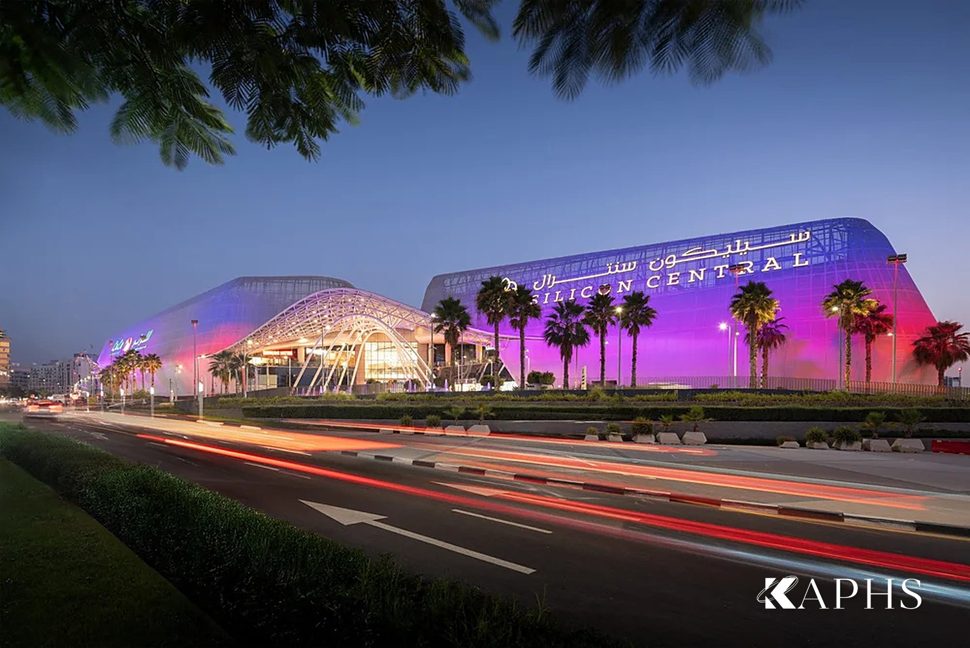 Silicon Central Mall's expanded metal mesh façade at dusk with light trails, Dubai — KAPHS