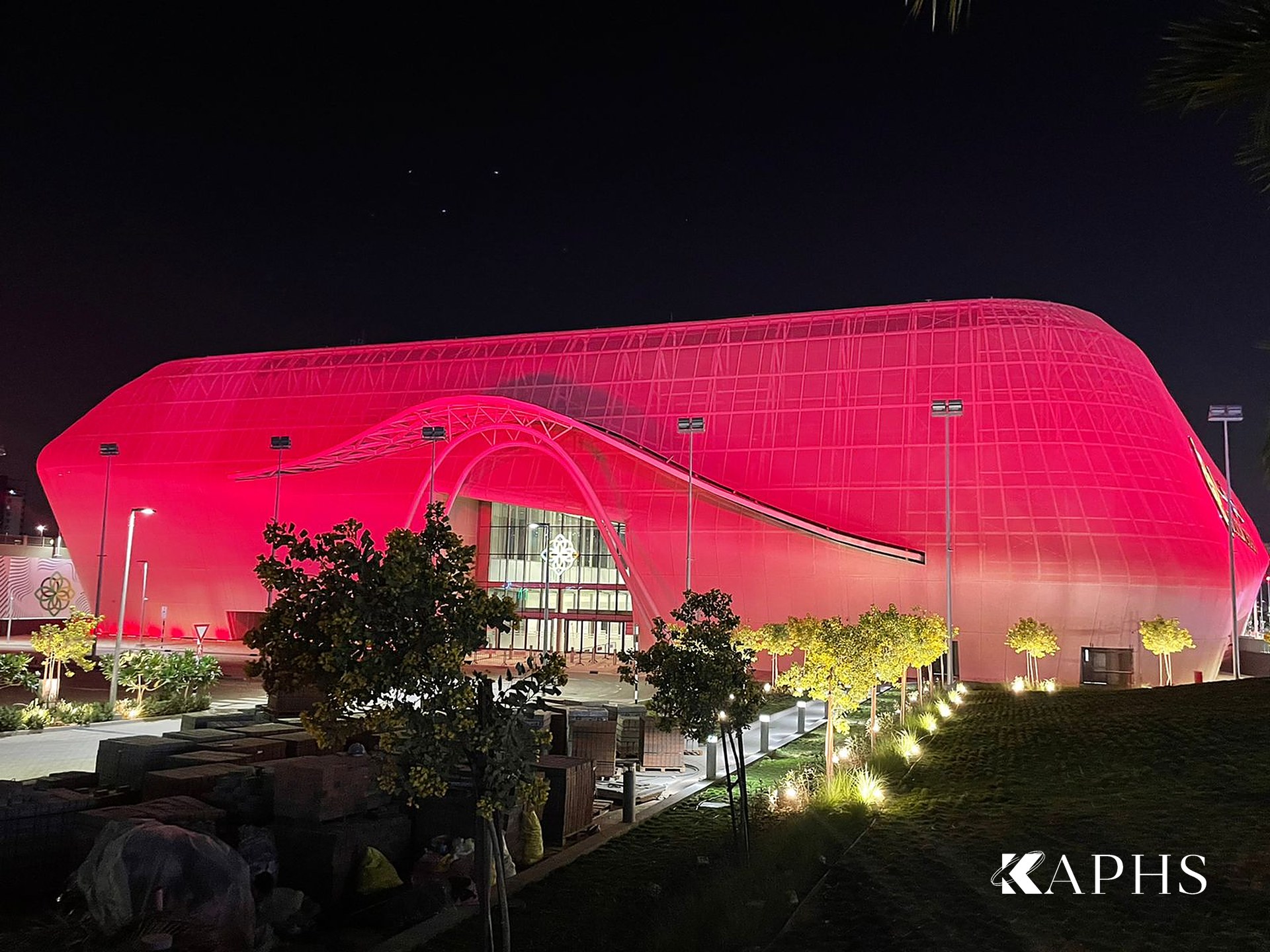 Silicon Central Mall illuminated red at night through its expanded metal mesh façade, Dubai — KAPHS