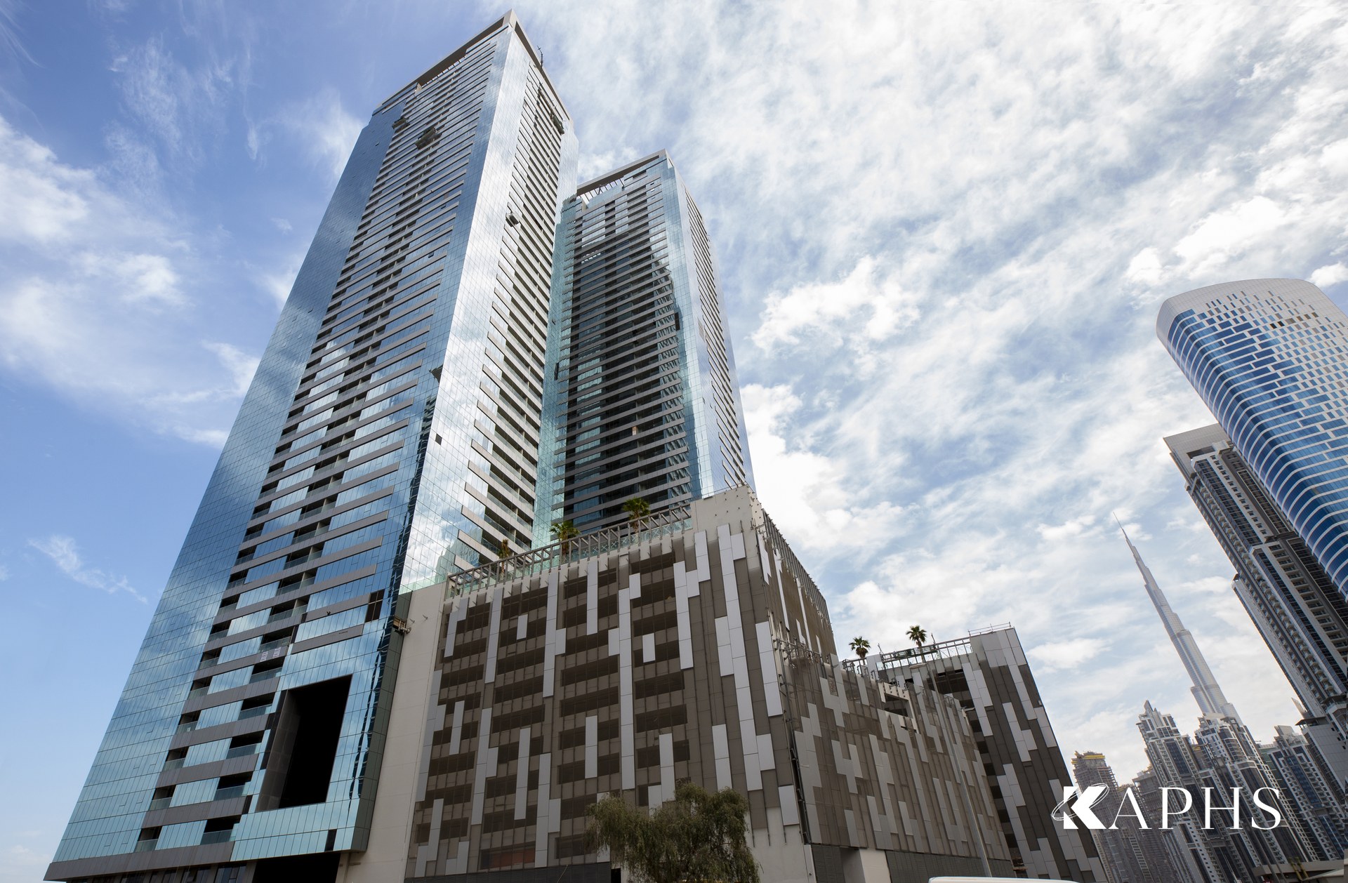 Tiara United Towers rising above the ExpandForm Saarbrücken expanded metal mesh car-park cladding, Dubai — KAPHS