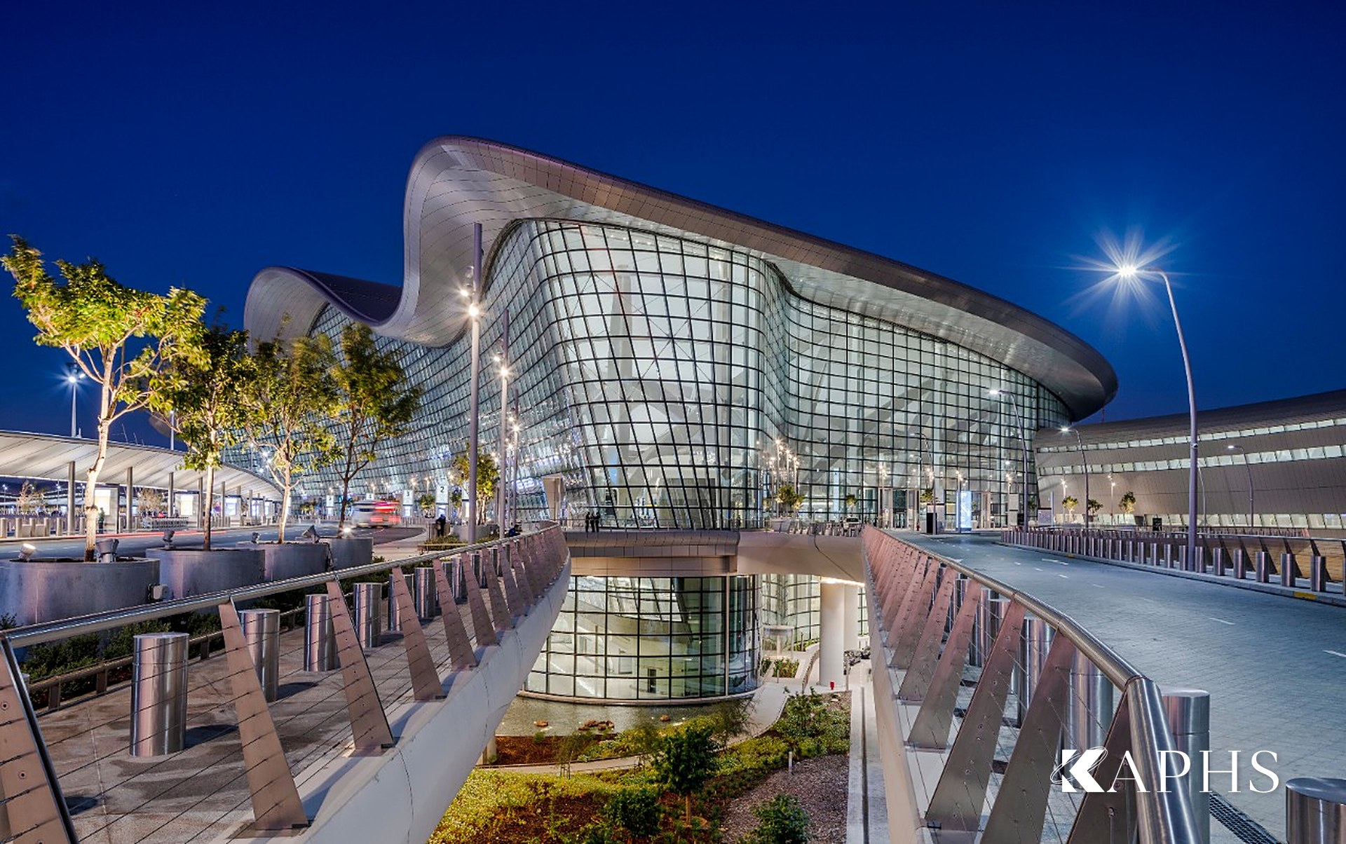 Zayed International Airport terminal glazing in coated NorthGlass jumbo glass at night, Abu Dhabi — KAPHS