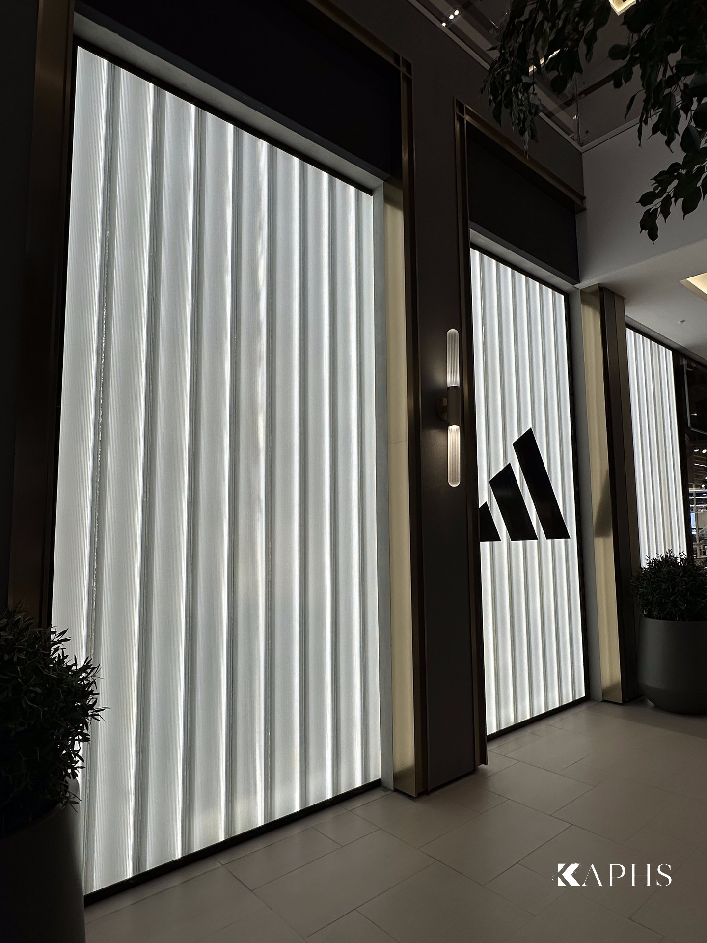 Backlit channel glass wall on the shop floor, adidas Dubai Hills Mall — KAPHS