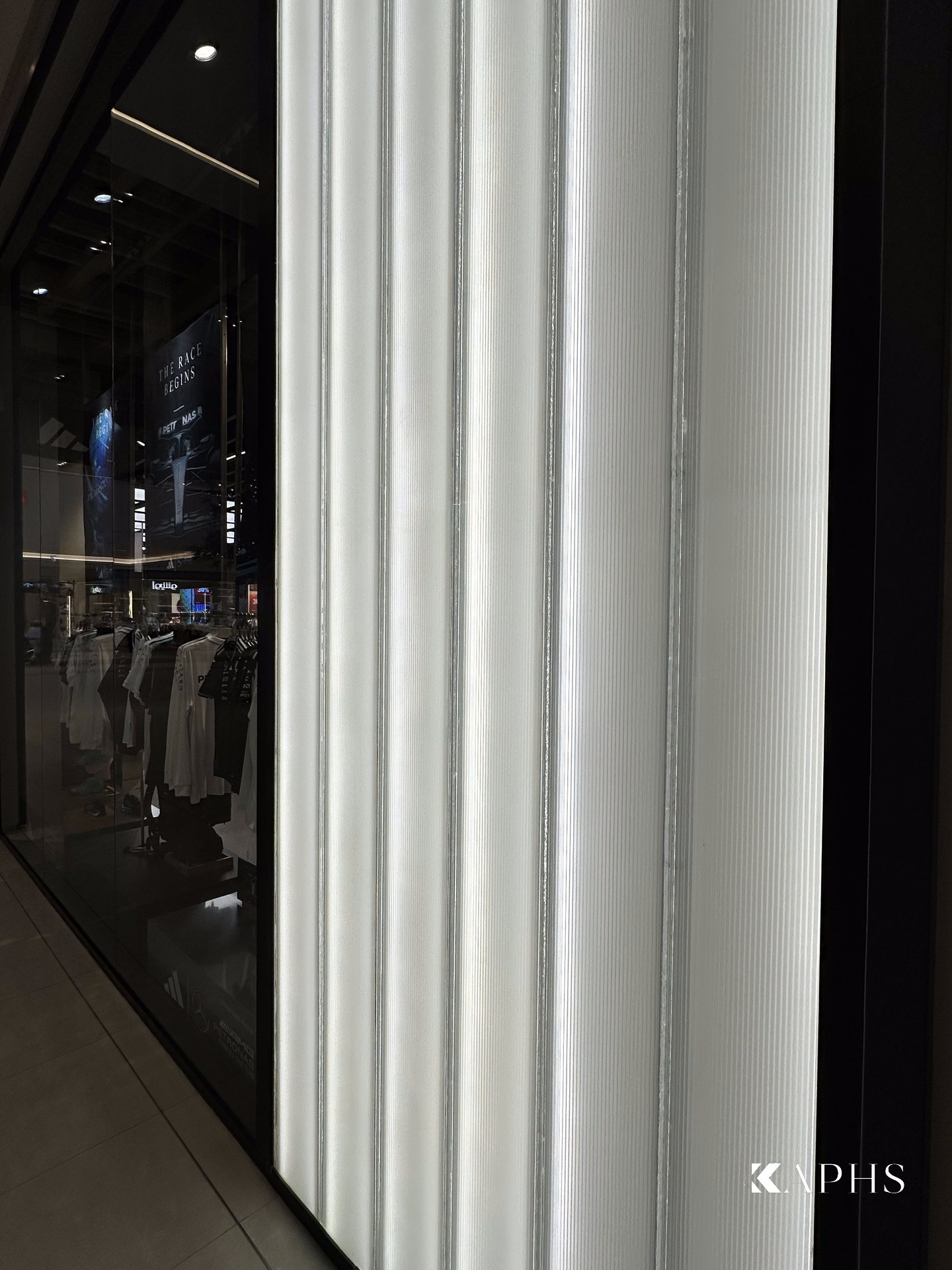 Translucent U-channel glass display backdrop, adidas Dubai Hills Mall — KAPHS
