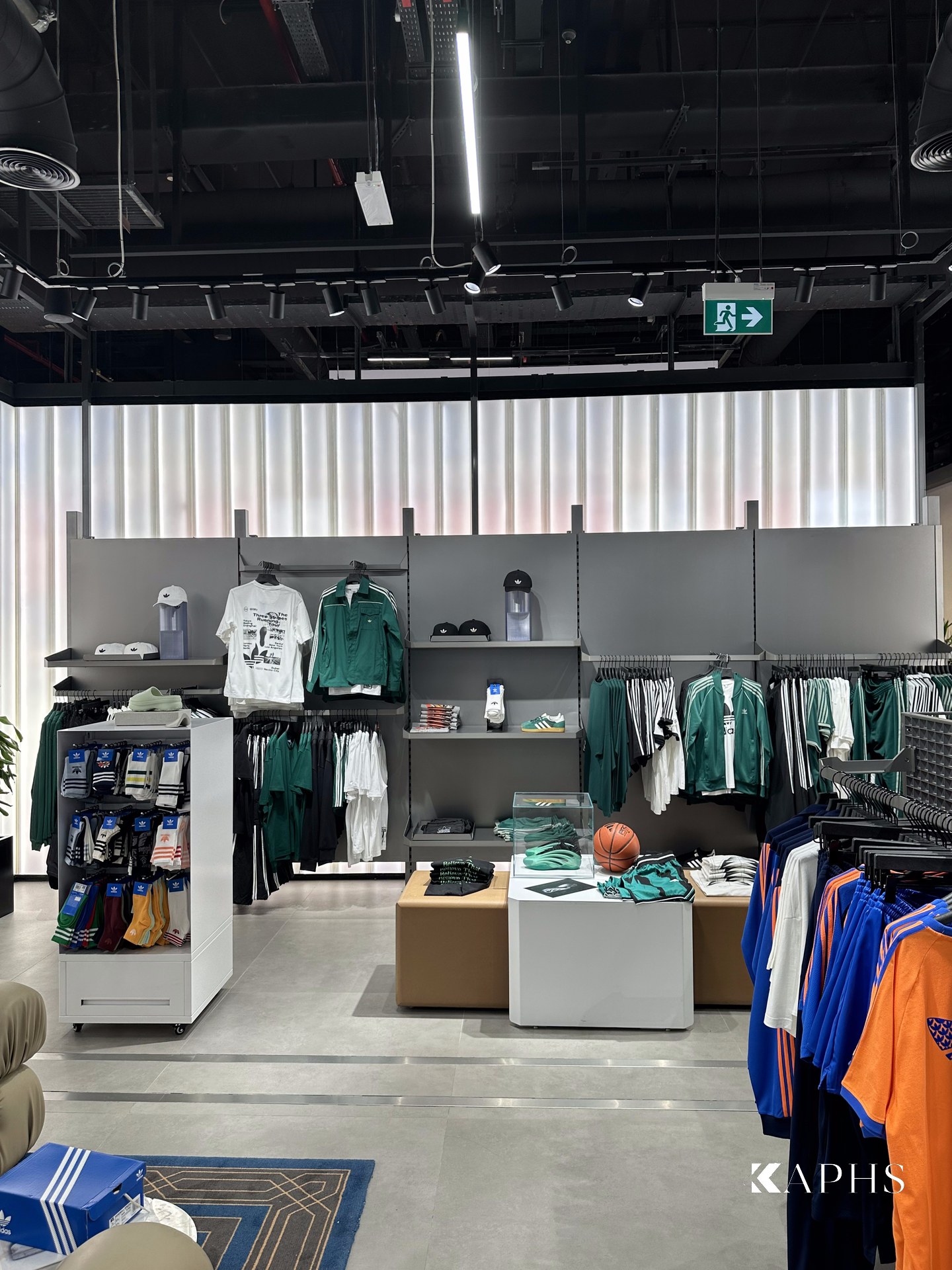 LINIT U-channel glass wall behind the display rails, adidas Flagship Store Dubai Mall — KAPHS