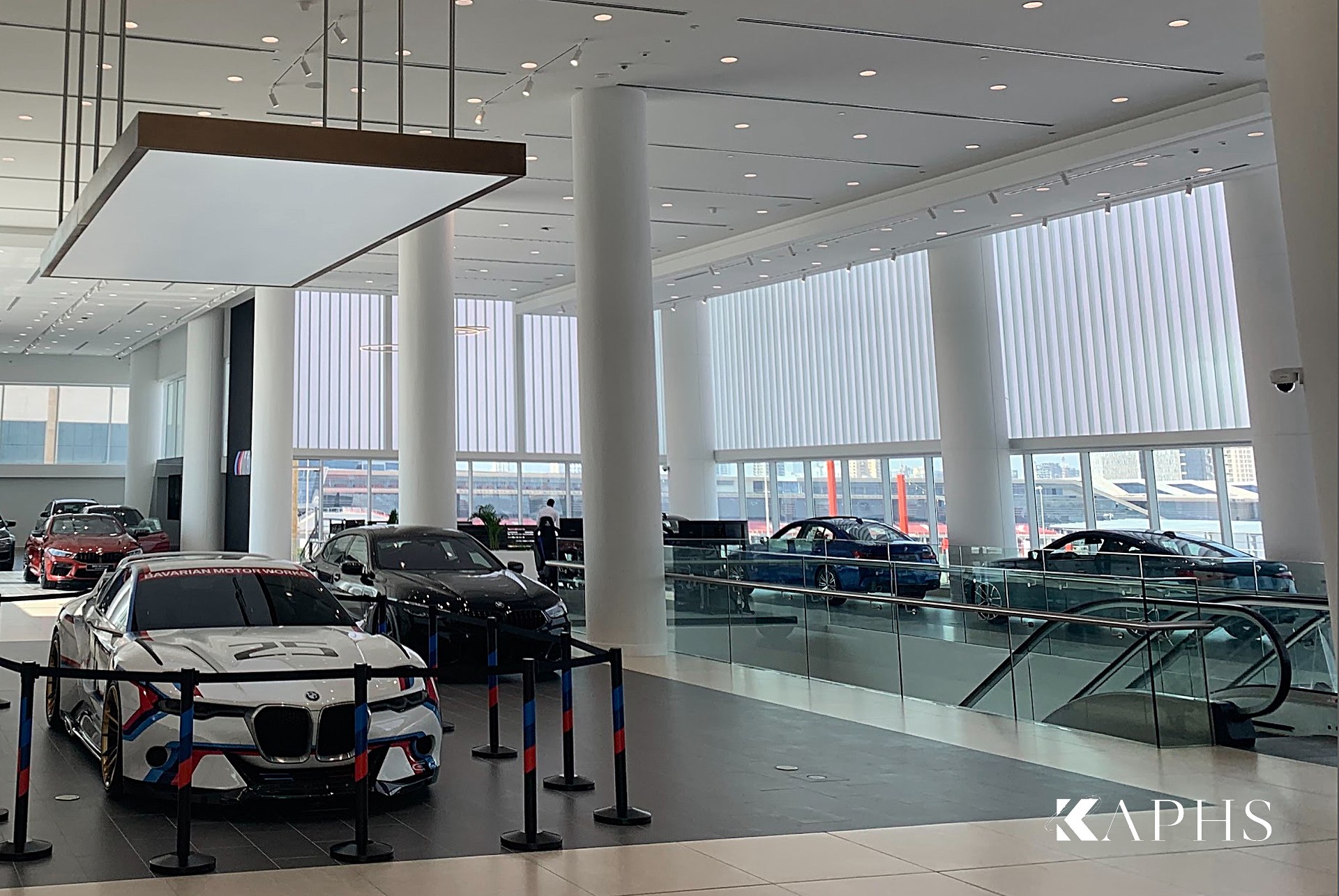 AGMC BMW showroom, Motor City Dubai — showroom interior with translucent U-channel glass windows, KAPHS
