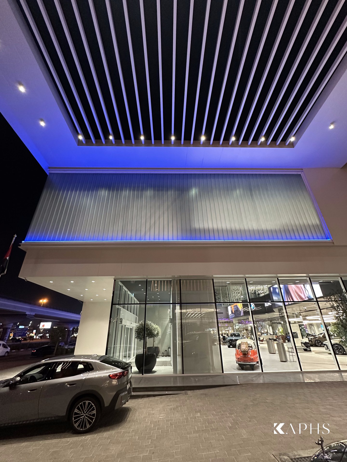 AGMC BMW showroom, Sheikh Zayed Road — LINIT U-channel glass fascia beneath the entrance canopy, KAPHS Dubai