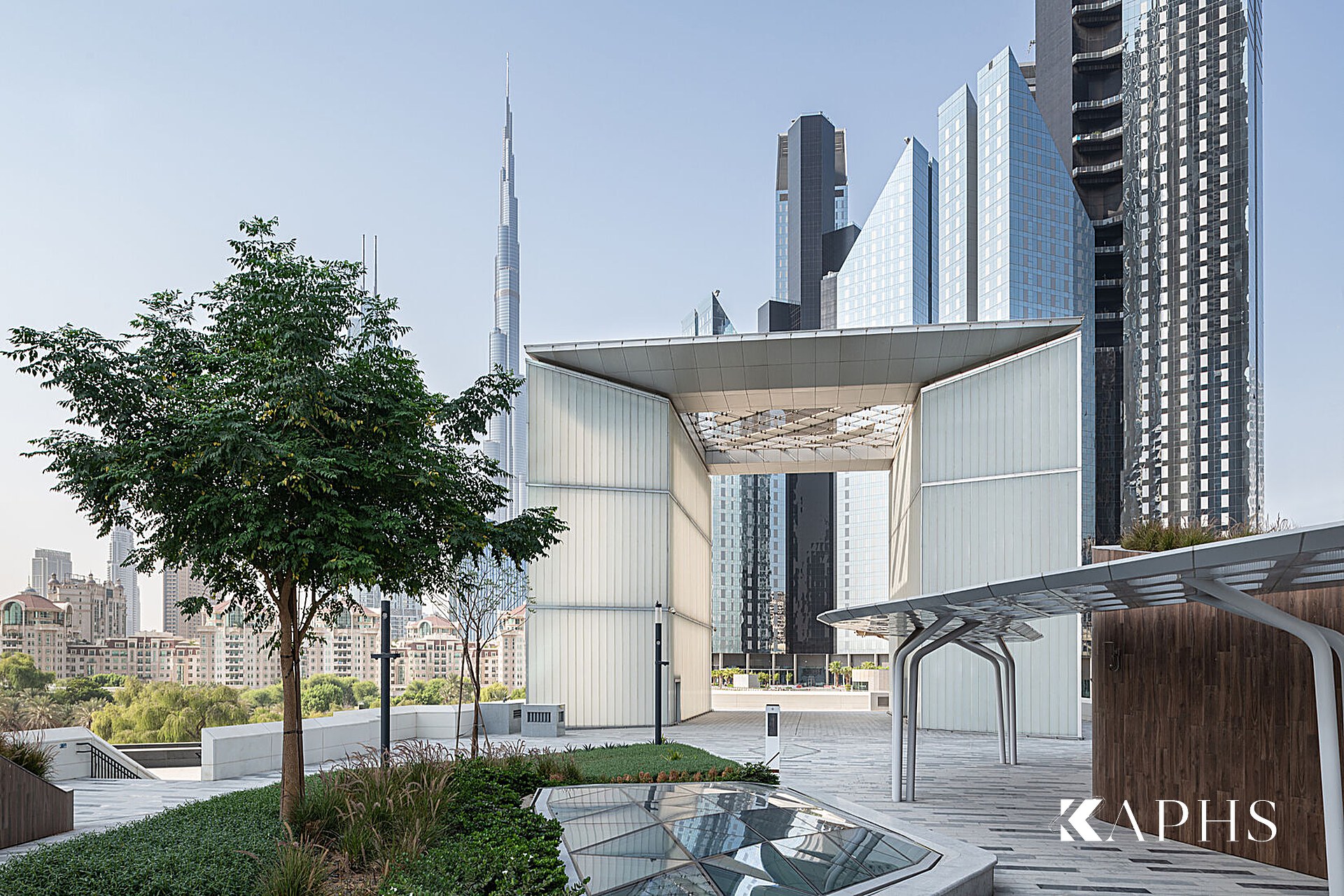 DIFC Gate Avenue by day — LINIT U-channel glass gateway with Burj Khalifa beyond, KAPHS