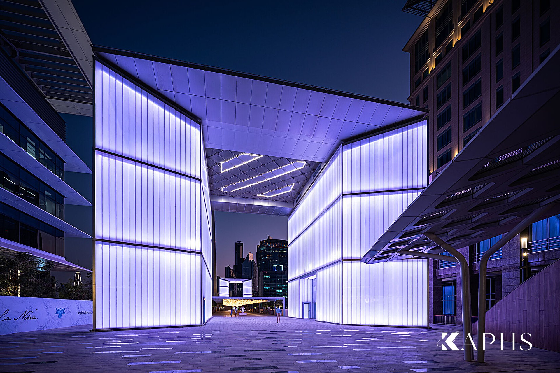 DIFC Gate Avenue — glowing U-channel glass pavilion at dusk, Dubai, KAPHS