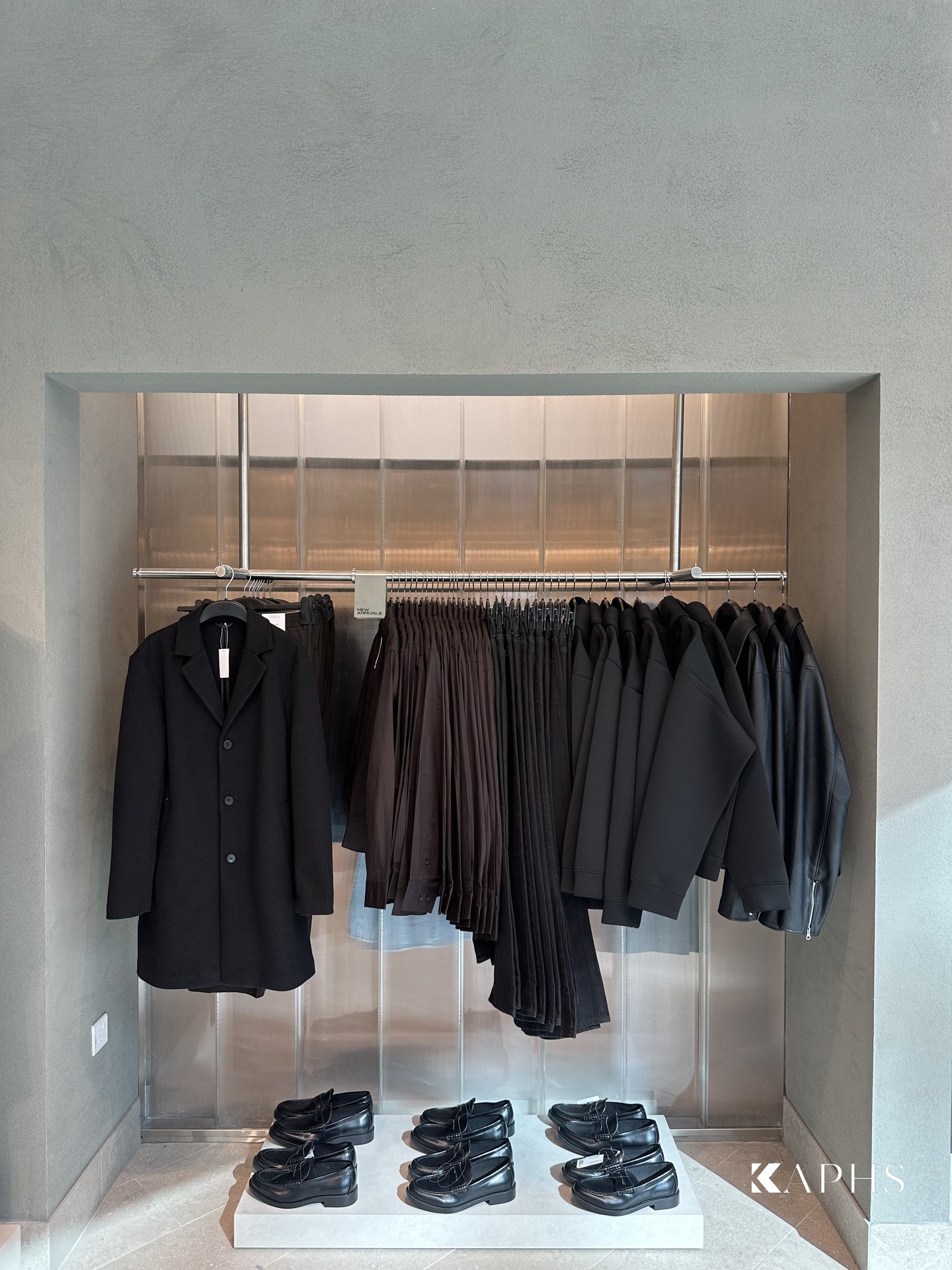 Backlit LINIT U-channel glass partition behind the display rails, H&M Yas Mall — KAPHS