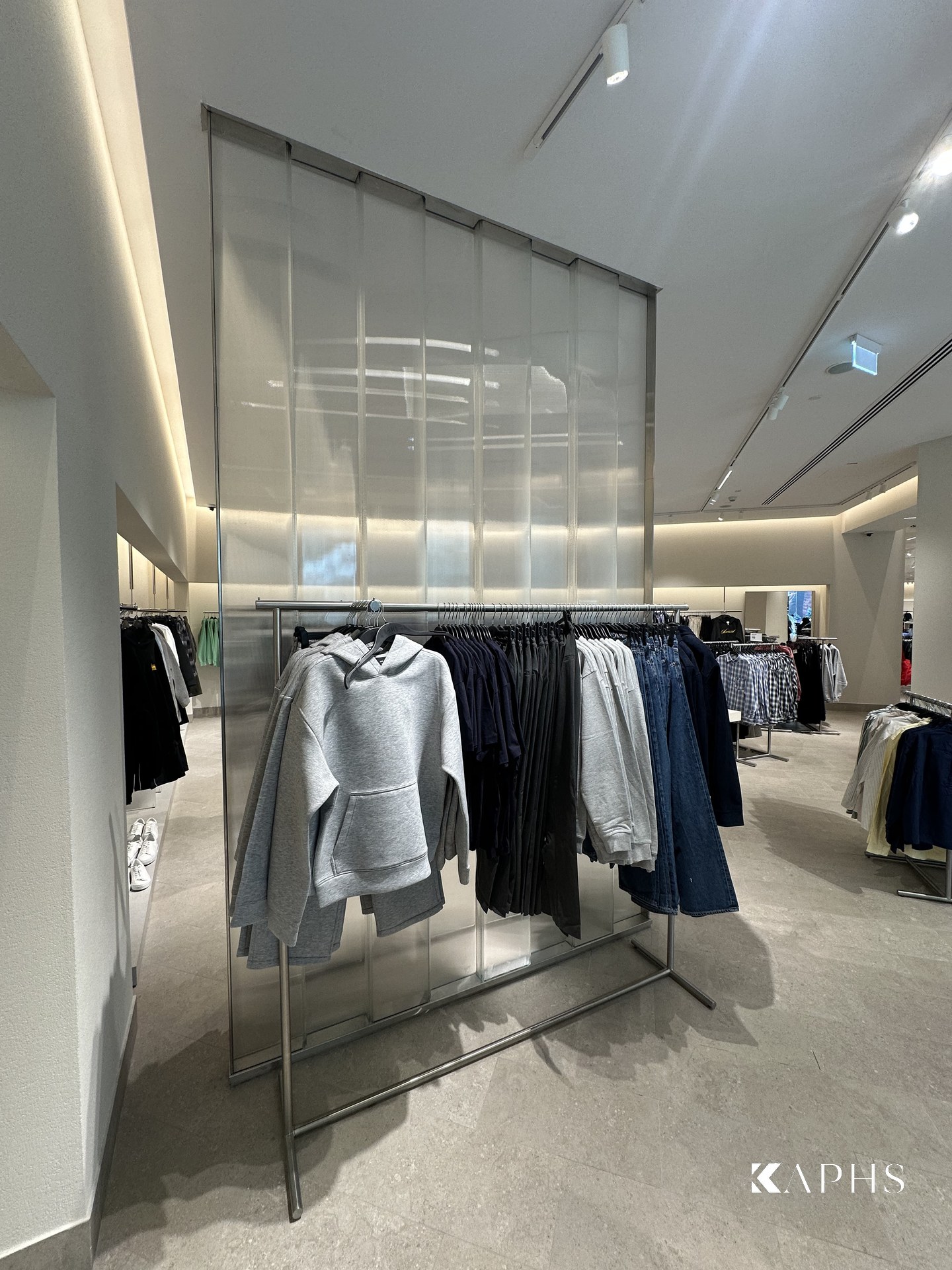Backlit LINIT U-channel glass backdrop to a clothing display, H&M Yas Mall — KAPHS
