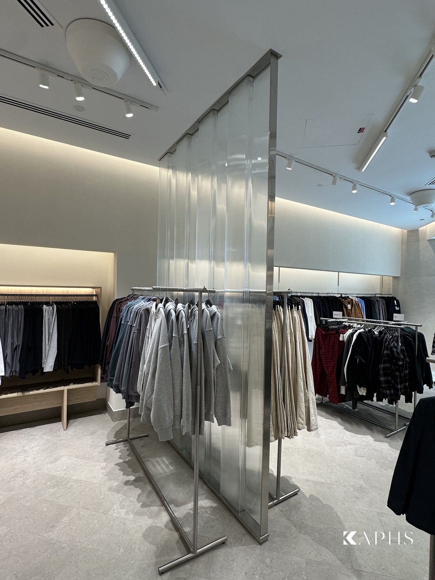 LINIT U-channel glass feature panel above the shop-floor rails, H&M Yas Mall — KAPHS