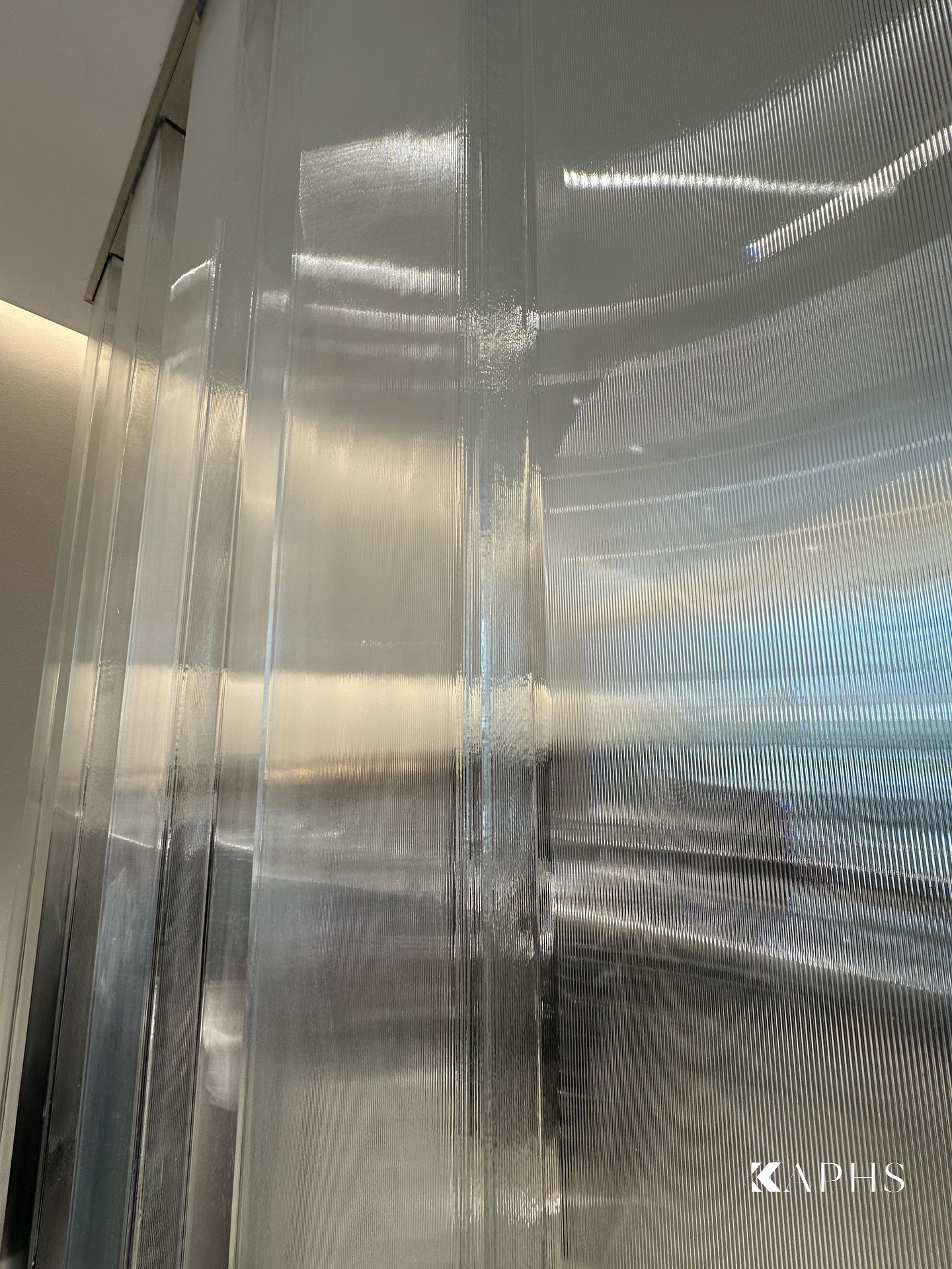 Backlit U-channel glass wall in the H&M Yas Mall store — KAPHS