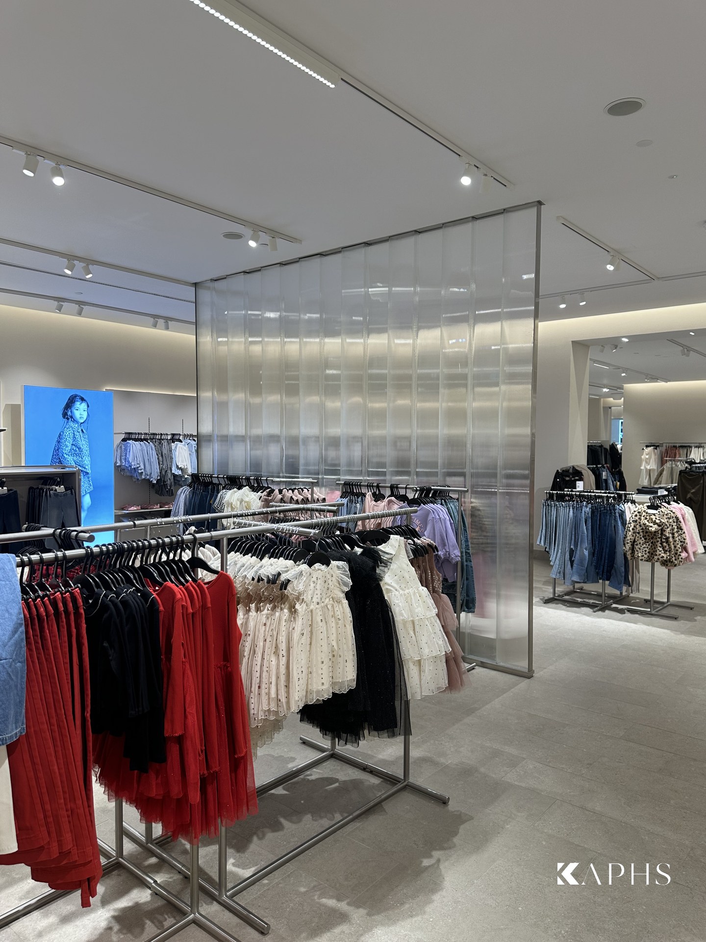 Softly lit U-channel glass feature wall, H&M Yas Mall store — KAPHS