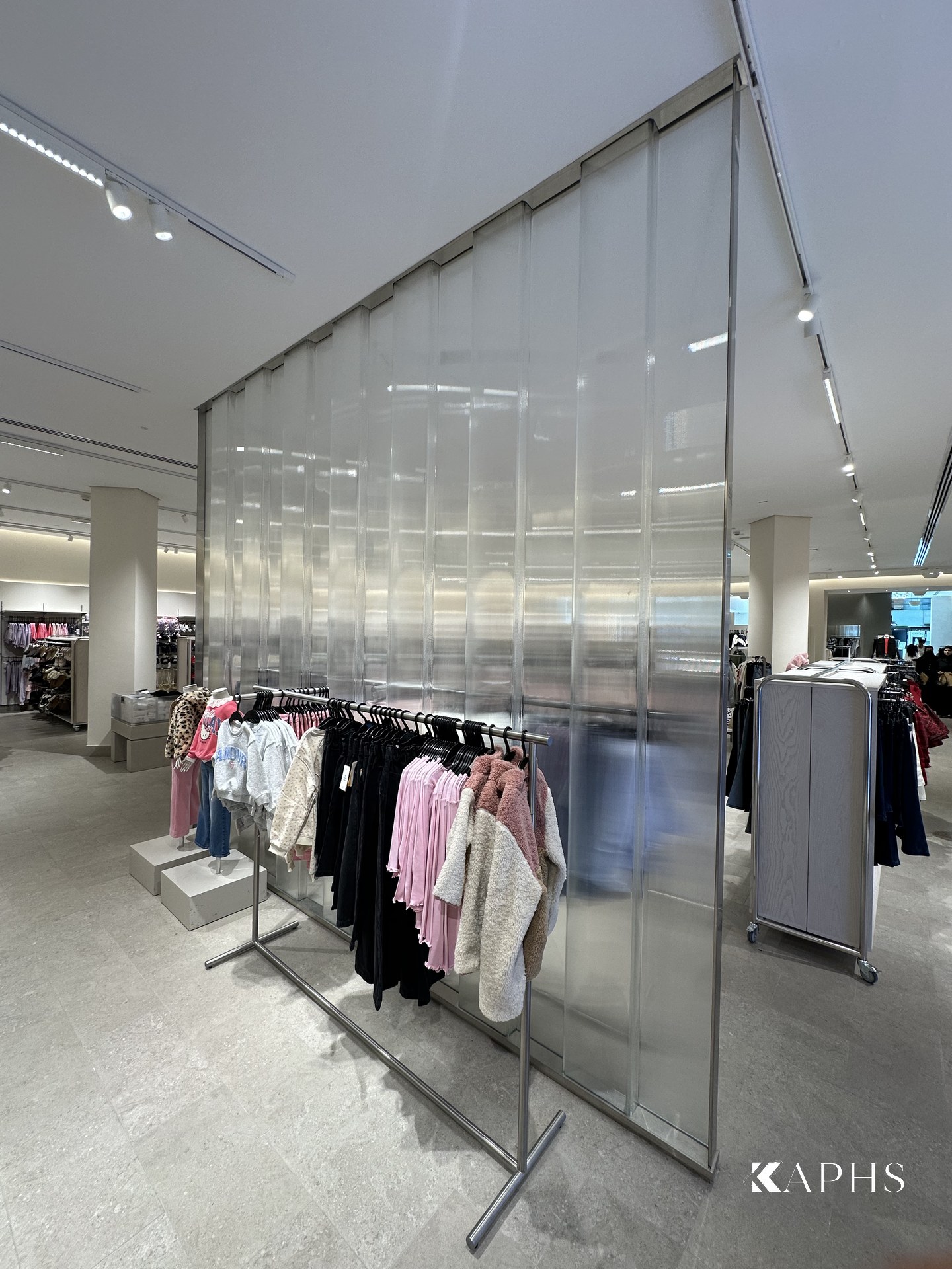 LINIT U-channel glass feature wall beside the shop-floor rails, H&M Yas Mall — KAPHS