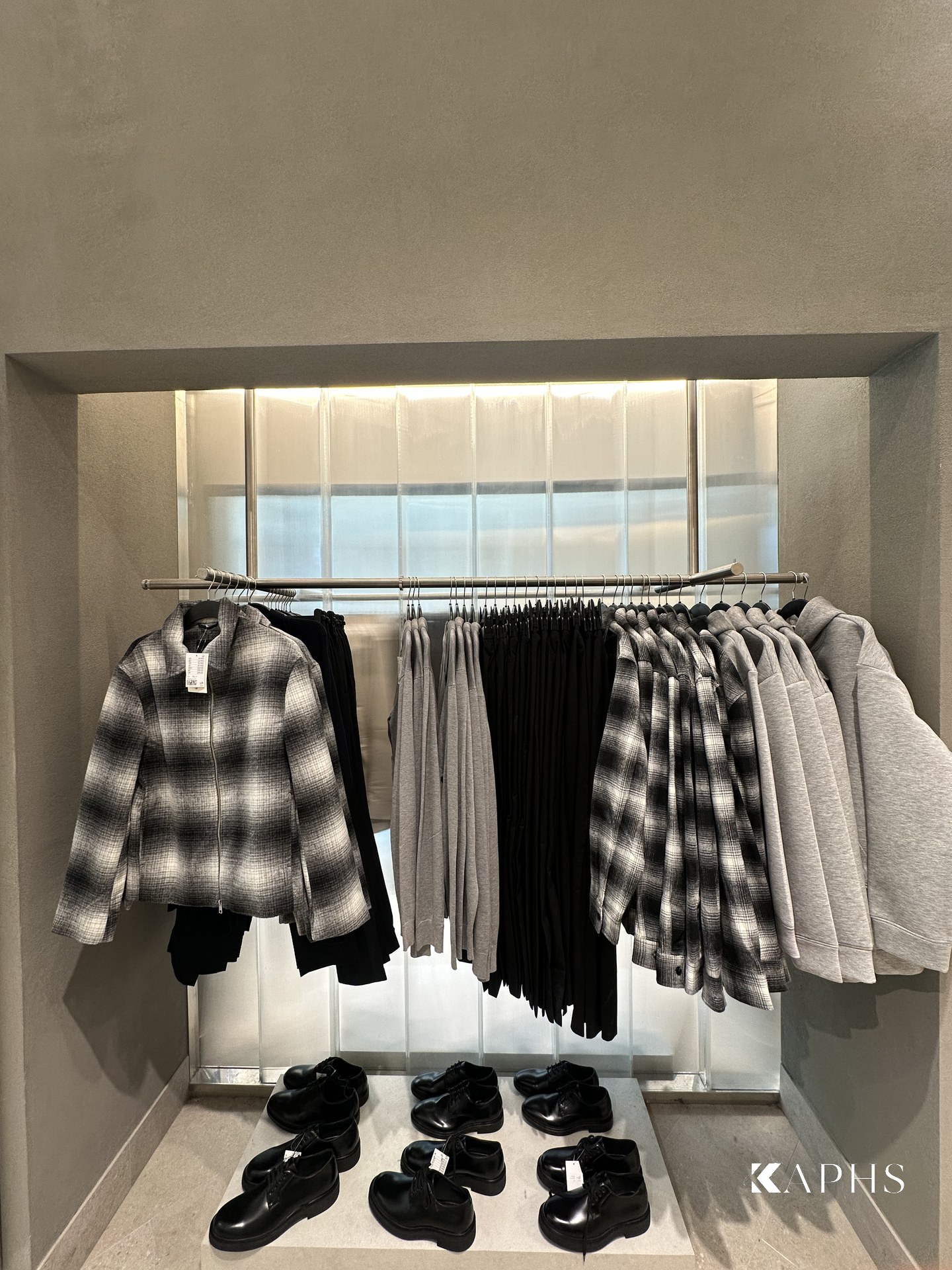 Translucent channel glass wall with clothing rail, H&M Yas Mall — KAPHS