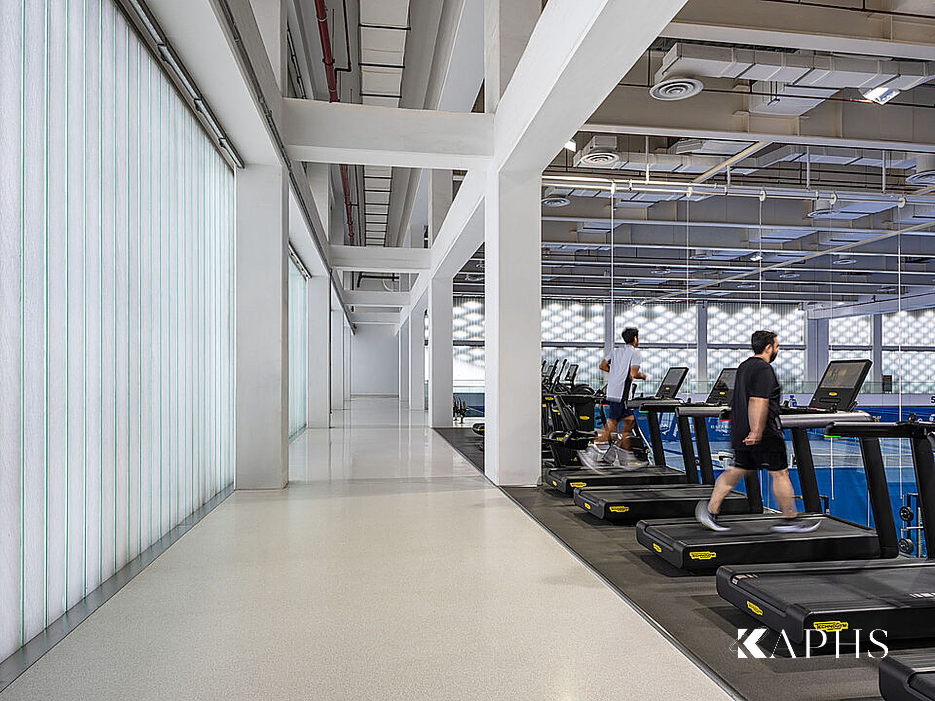 Gym walkway beside the translucent LINIT U-channel glass wall, Kuwait International Tennis Complex — KAPHS