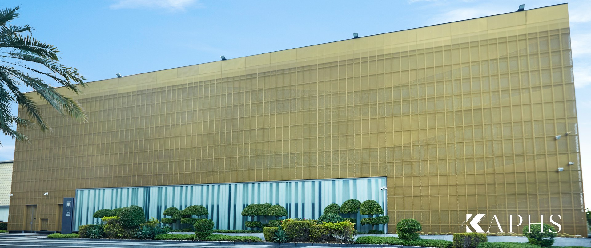 Gold mesh façade over a LINIT U-channel glass base band, The Beach JBR Dubai — KAPHS